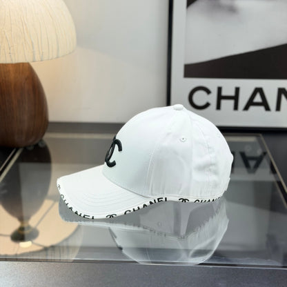 A white premium baseball cap with black embroidered logo details on a clean display surface.