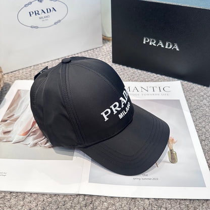 Black nylon baseball cap with white embroidered lettering and side metal logo plaque.
