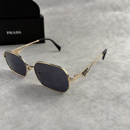 Geometric metal-frame sunglasses in gold tone with dark smoke lenses and signature triangular temple