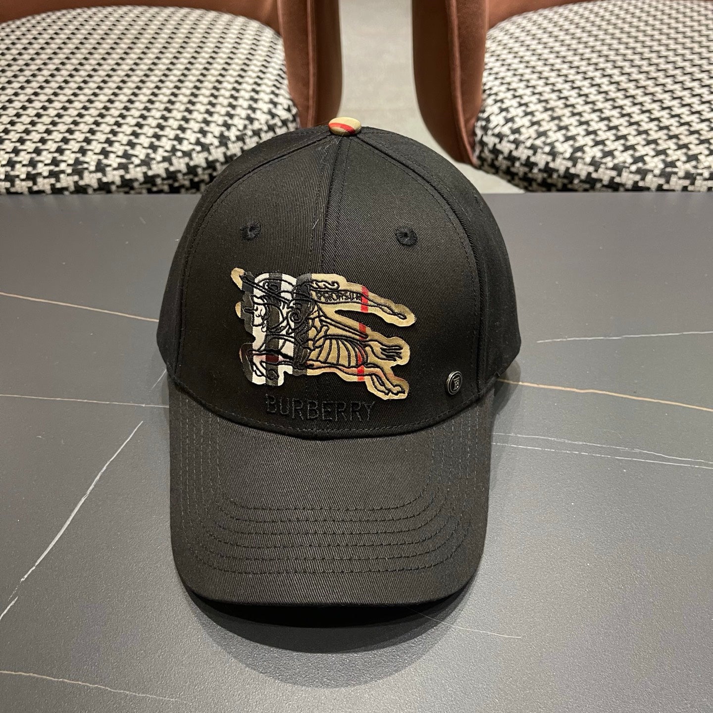 Black cotton baseball cap with intricate equestrian embroidery and a subtle metallic side accent.