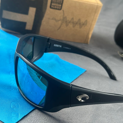 Matte black frame sport sunglasses with blue mirror lenses, including a protective case and cloth.