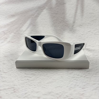 A pair of modern rectangular sunglasses with a bright white frame and dark tinted lenses.