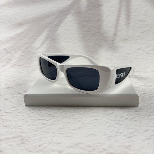 A pair of modern rectangular sunglasses with a bright white frame and dark tinted lenses.
