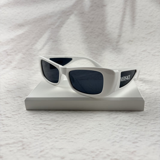 A pair of modern rectangular sunglasses with a bright white frame and dark tinted lenses.