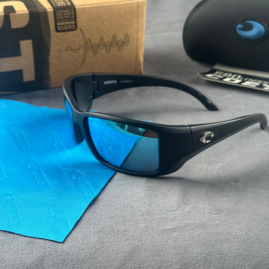 Matte black frame sport sunglasses with blue mirror lenses, including a protective case and cloth.