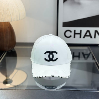 A white premium baseball cap with black embroidered logo details on a clean display surface.