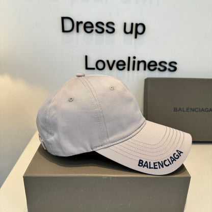 A grey cotton baseball cap with embroidered lettering, featuring a curved brim and adjustable back.
