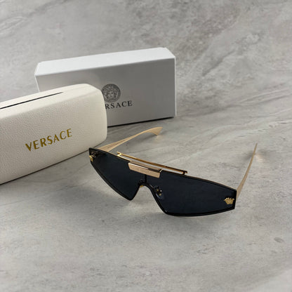 Gold metal frame shield sunglasses with dark lenses, featuring elegant temple detailing.