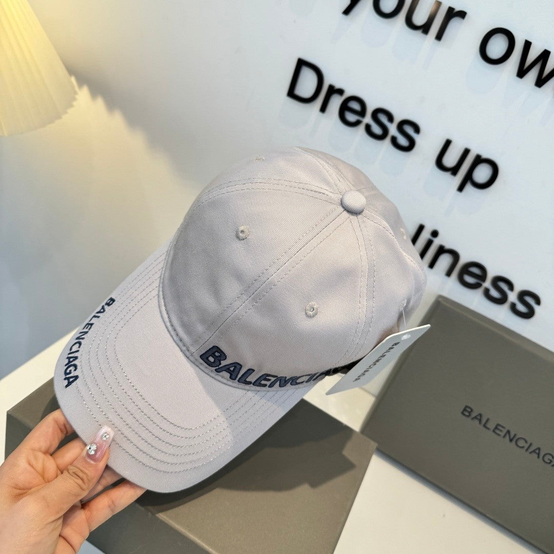 A grey cotton baseball cap with embroidered lettering, featuring a curved brim and adjustable back.