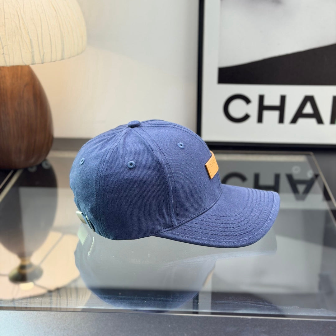 A navy blue cotton baseball cap with a rectangular tan leather-style patch on the front panel.