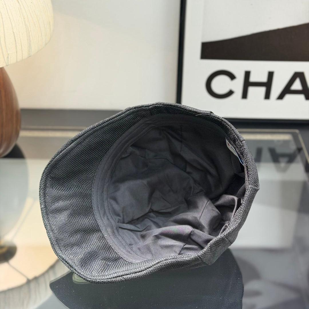 Close-up of a premium dark grey textured ivy cap with a white embroidered logo, high-quality fabric.