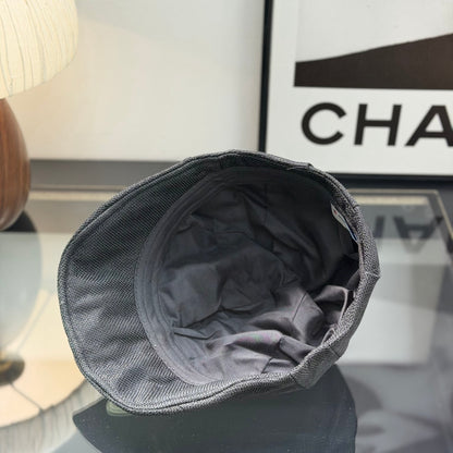 Close-up of a premium dark grey textured ivy cap with a white embroidered logo, high-quality fabric.